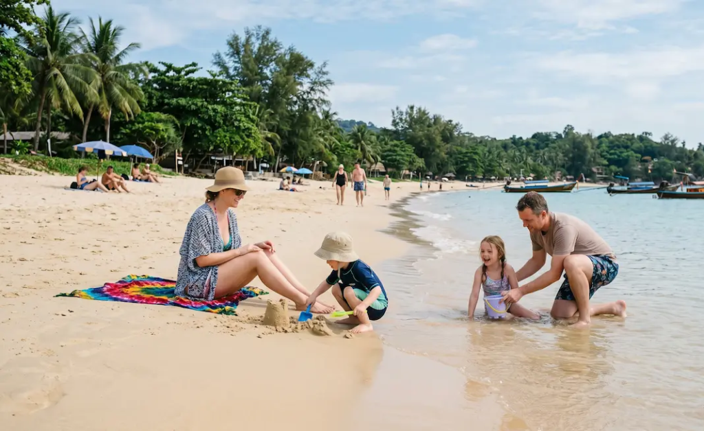 Family enjoying a relaxed Phuket beach holiday with children playing by the shoreline during a 7-day Family Phuket Holiday package